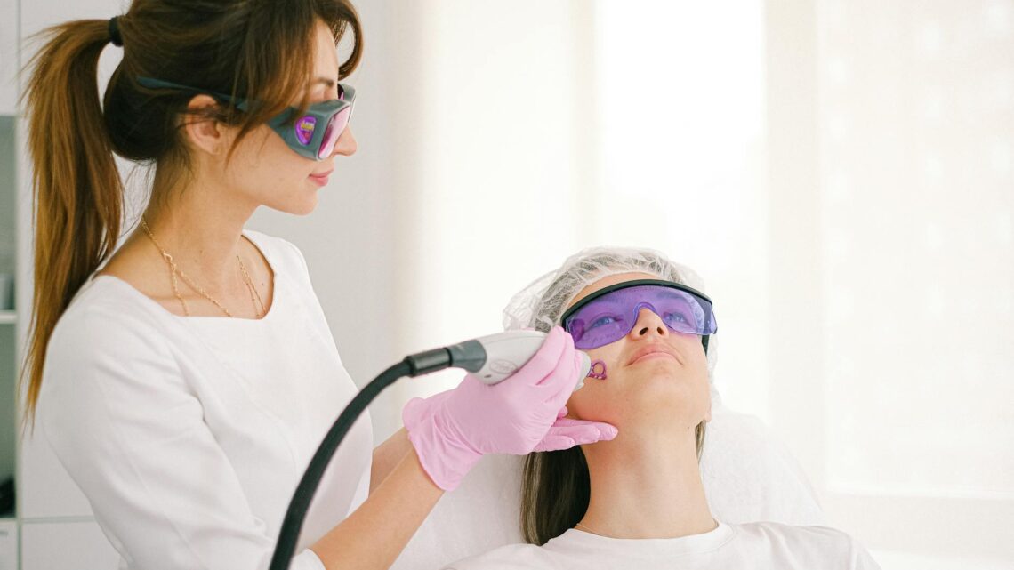 cosmetologist performing scar whitening on a woman